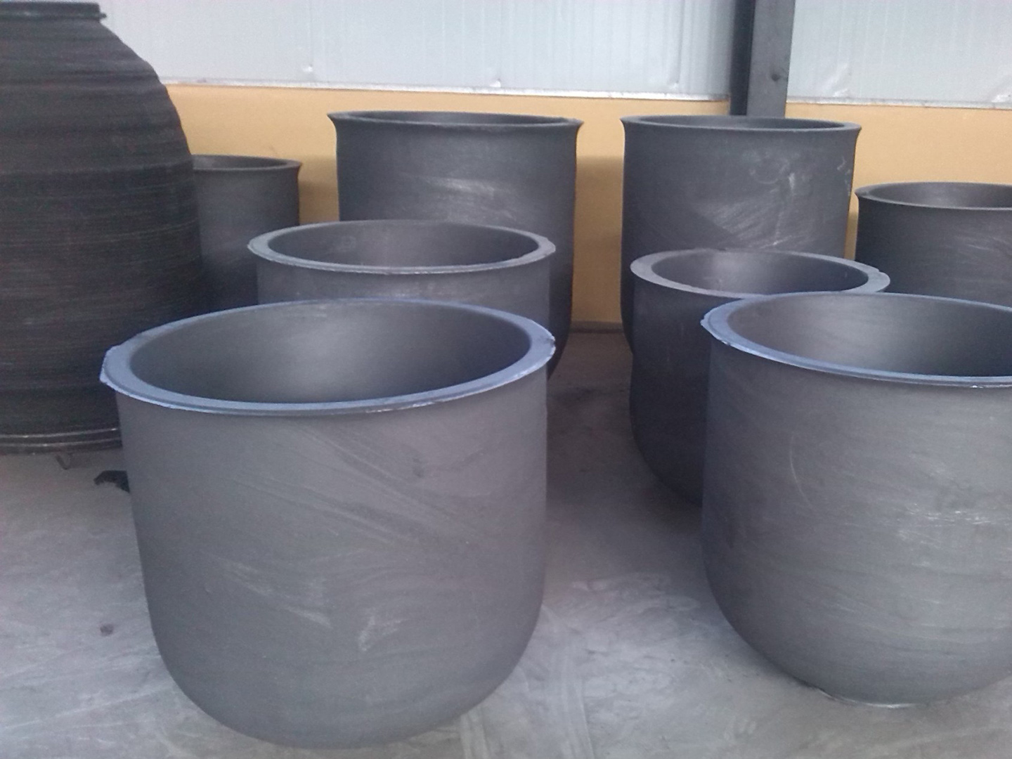 Utensils for melting metals or other substances, generally made of refractory materials such as clay and graphite1